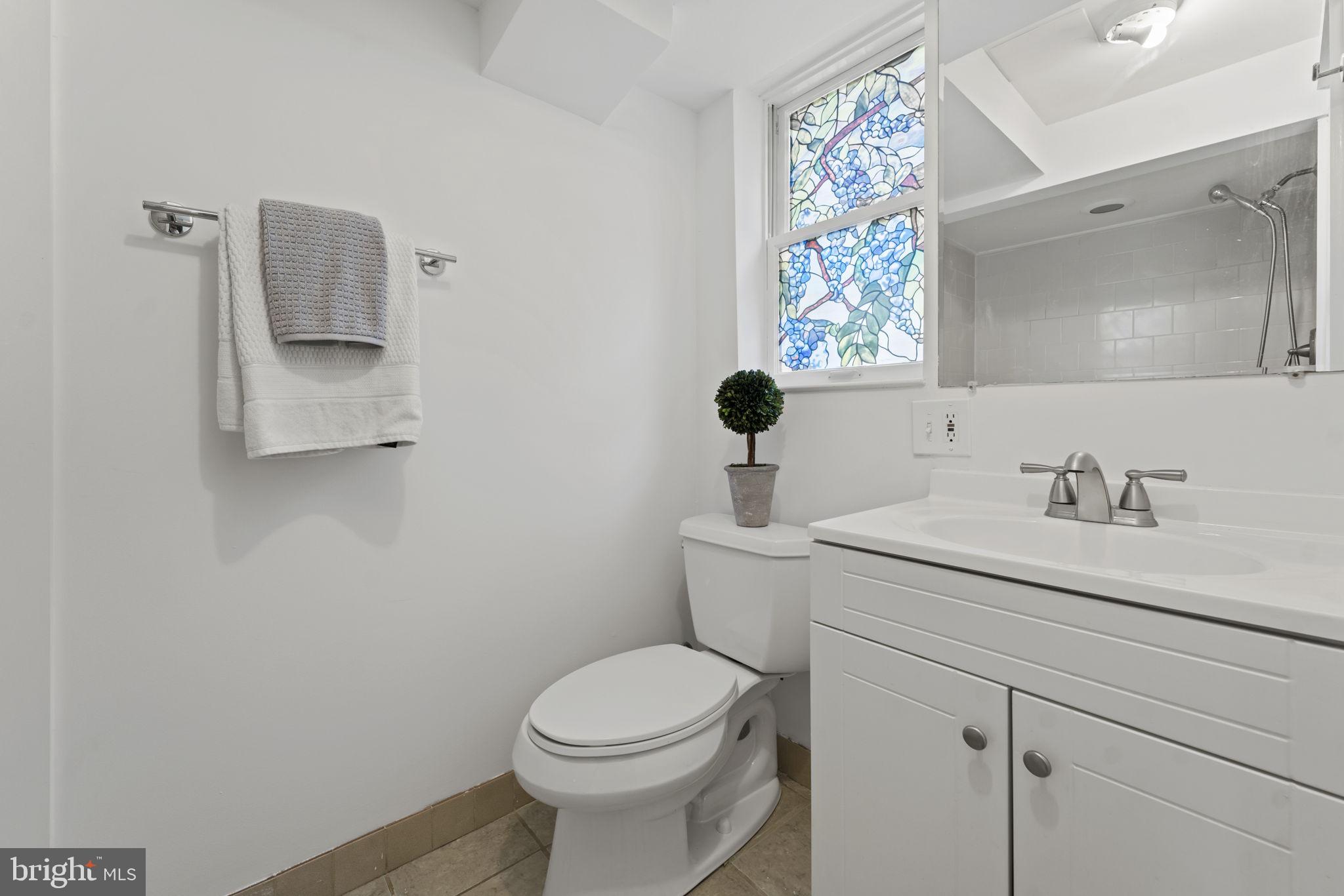10122 Greenock Road Silver Spring, MD 20901 - Photo 19 of 25 a bathroom with a toilet sink and mirror