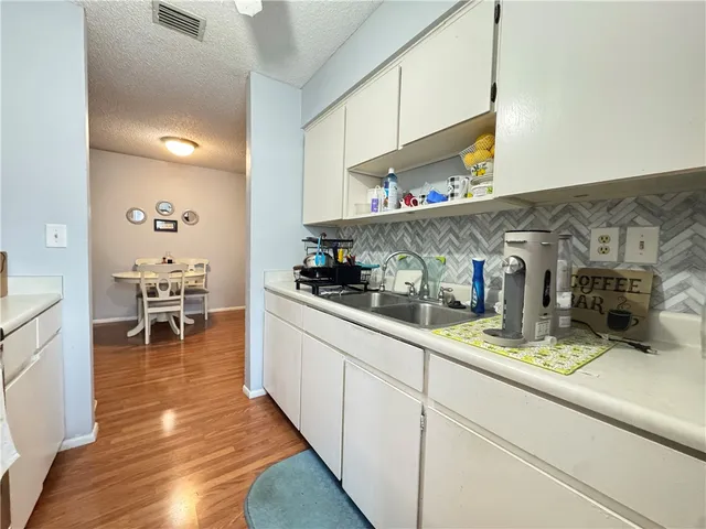 a kitchen with sink and cabinets