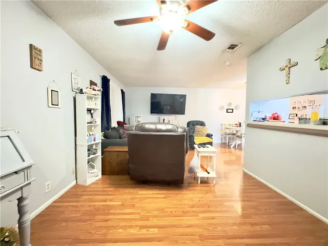 a view of a kitchen with fridge and workspace