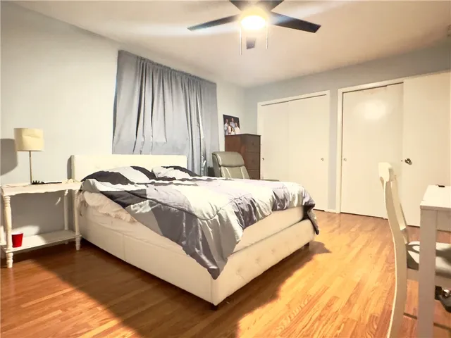 a spacious bedroom with a bed and a chandelier