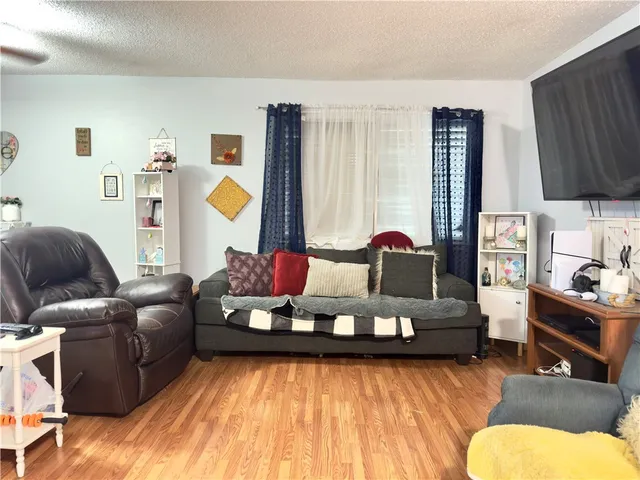 a living room with furniture and a lamp