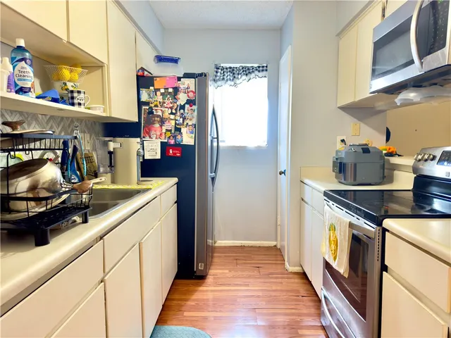 a kitchen with stainless steel appliances granite countertop a stove and a sink