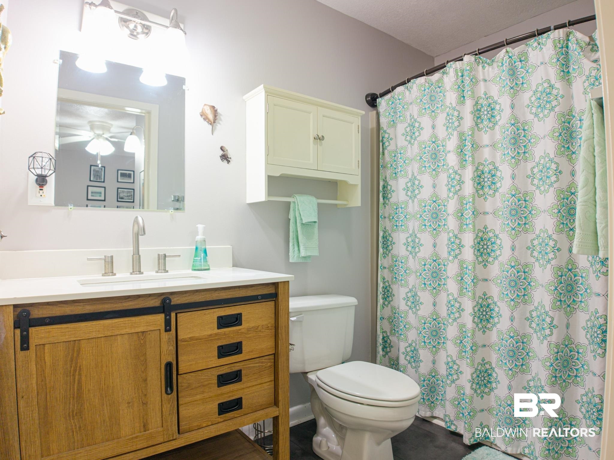 1563 Valencia Drive Lillian, AL 36549 - Photo 16 of 27 Full bathroom with vanity, curtained shower, and ceiling fan