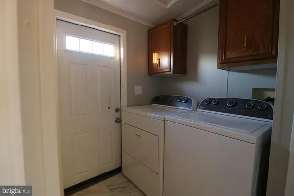 a utility room with closet dryer and washer