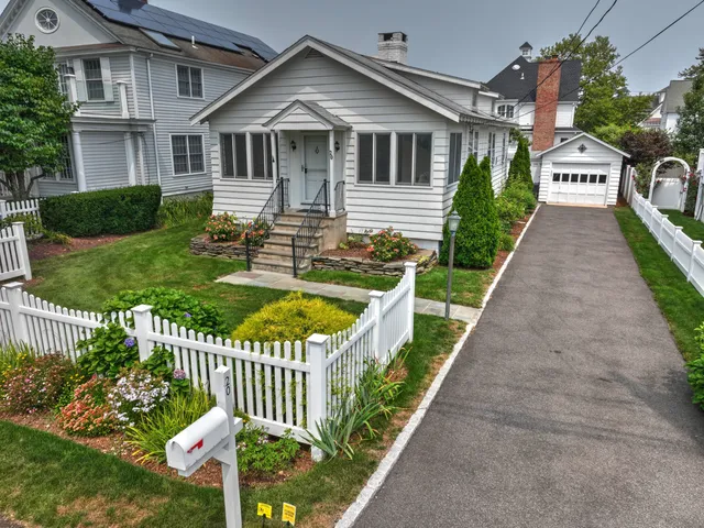 a front view of a house with a yard table and chairs