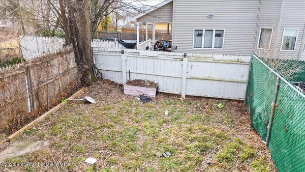 a view of a backyard with sitting area