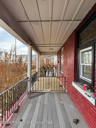 a view of a balcony with wooden floor