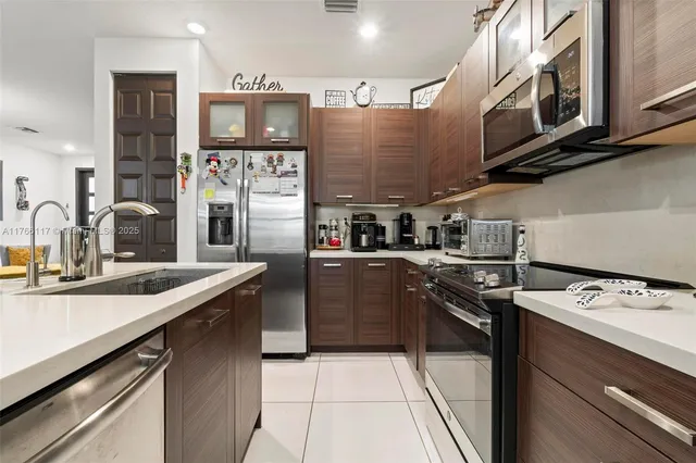 a kitchen with stainless steel appliances granite countertop a sink and stove top oven