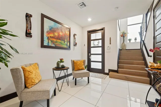 a living room with furniture and a painting on the wall