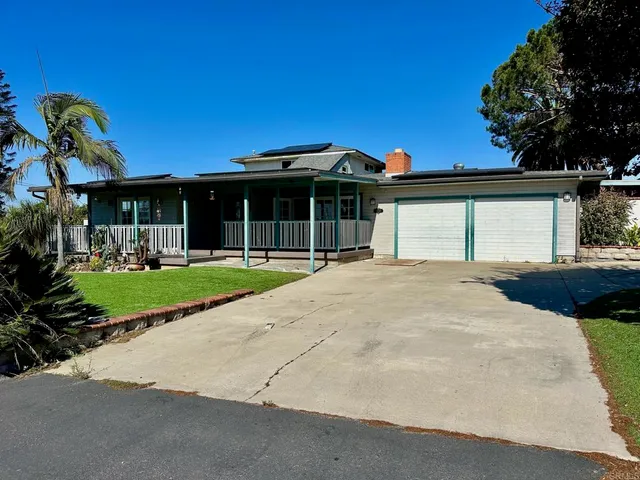 a view of house with yard and entertaining space