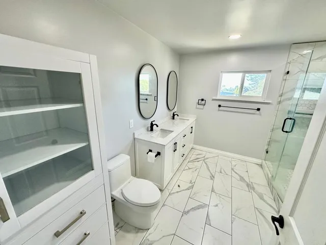 a view of a room with wooden floor and white walls