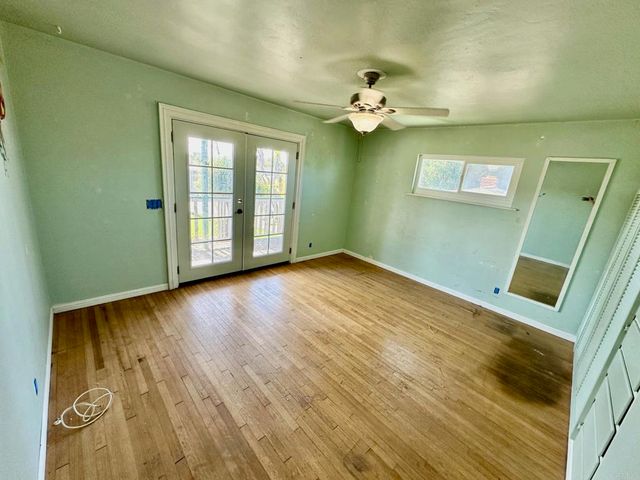 a bathroom with a granite countertop toilet sink and mirror