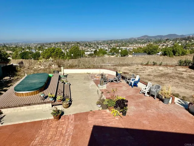 a view of a terrace with wooden floor and a ocean view
