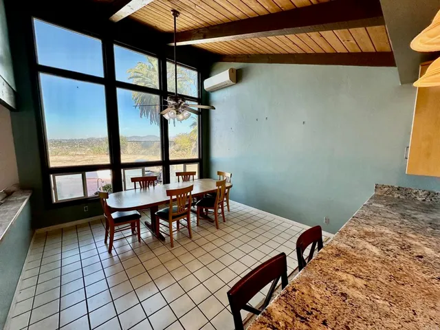 a dining room with furniture and a window