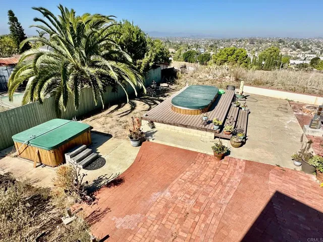 a view of a backyard with sitting area