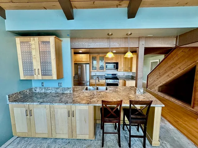 a kitchen with cabinets and window