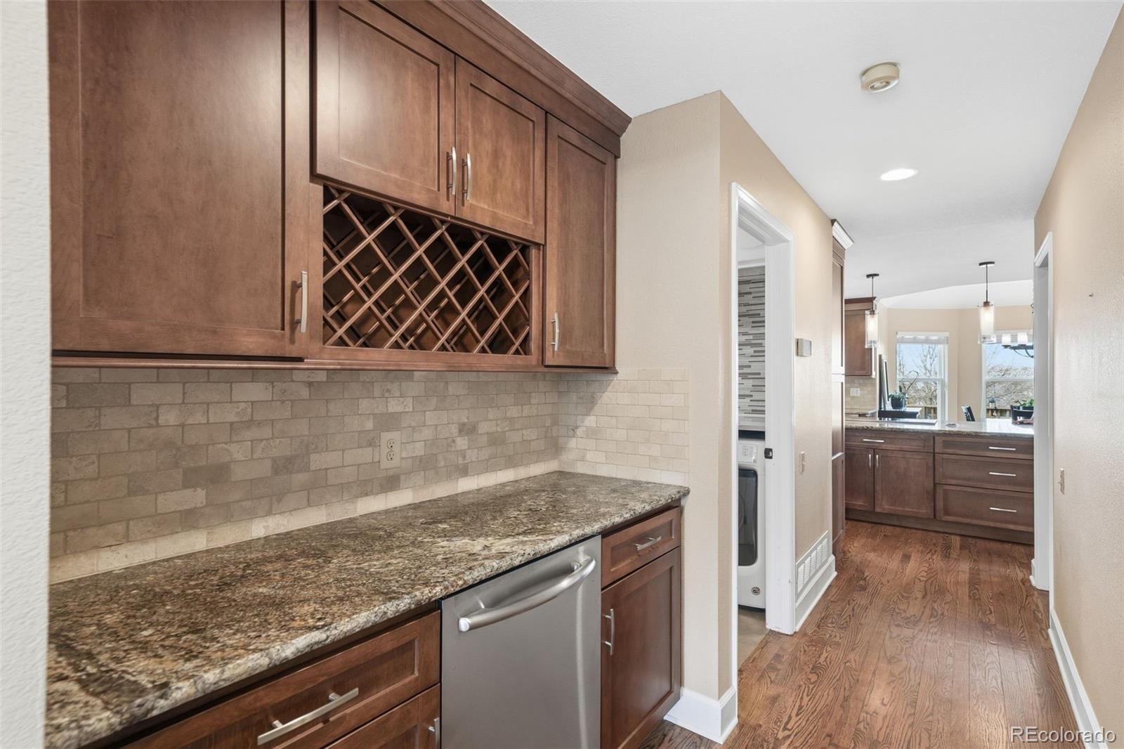 6879 Ingleton Drive Castle Pines, CO 80108 - Photo 12 of 50 a kitchen with a sink and refrigerator