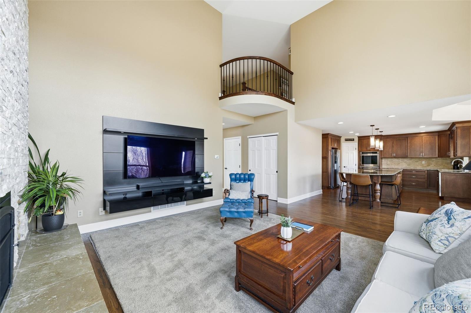 6879 Ingleton Drive Castle Pines, CO 80108 - Photo 14 of 50 a living room with furniture and a flat screen tv