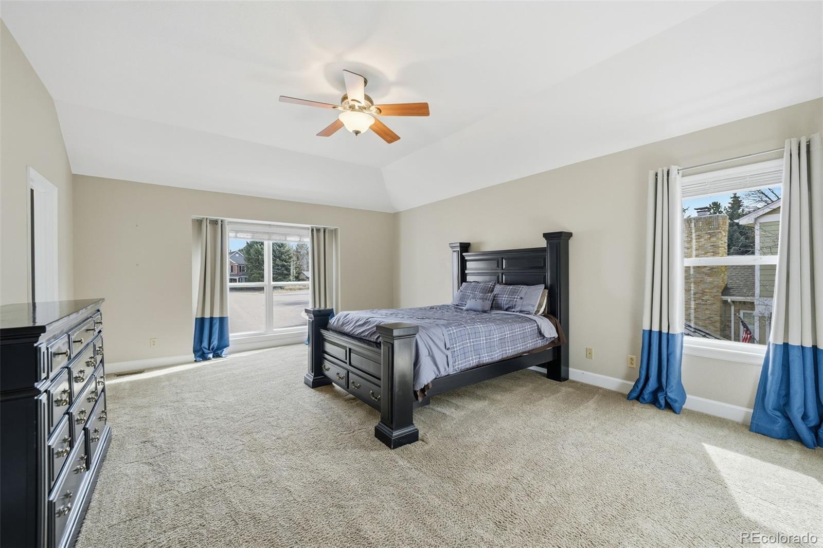 6879 Ingleton Drive Castle Pines, CO 80108 - Photo 21 of 50 a bed sitting in a bedroom next to a window