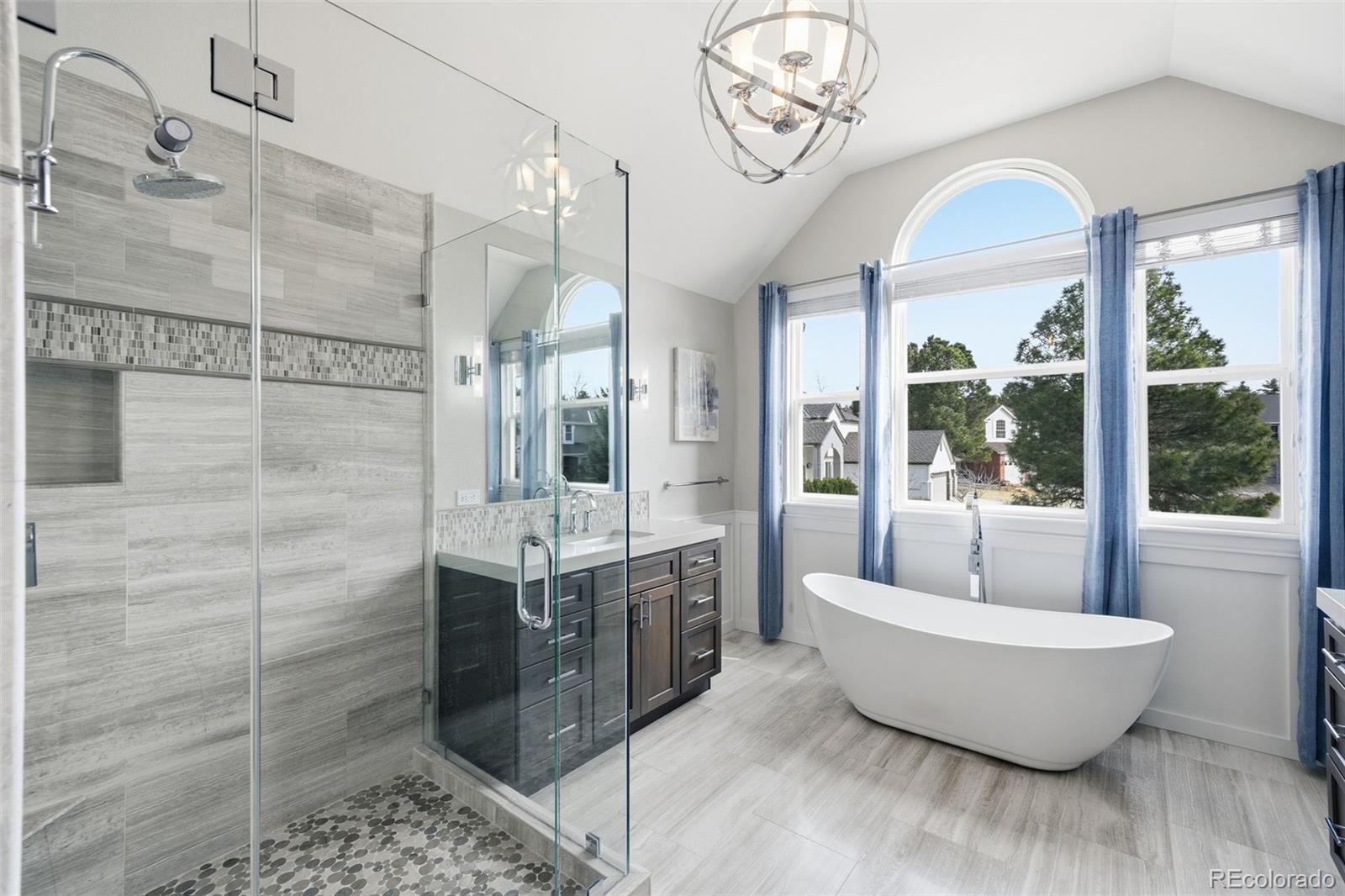 6879 Ingleton Drive Castle Pines, CO 80108 - Photo 23 of 50 a spacious bathroom with a bathtub and shower