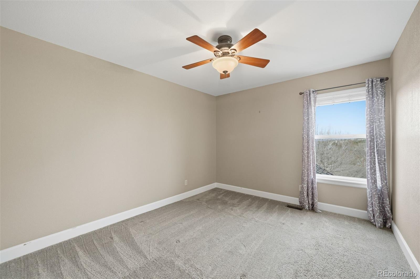 6879 Ingleton Drive Castle Pines, CO 80108 - Photo 30 of 50 an empty room with fan and windows