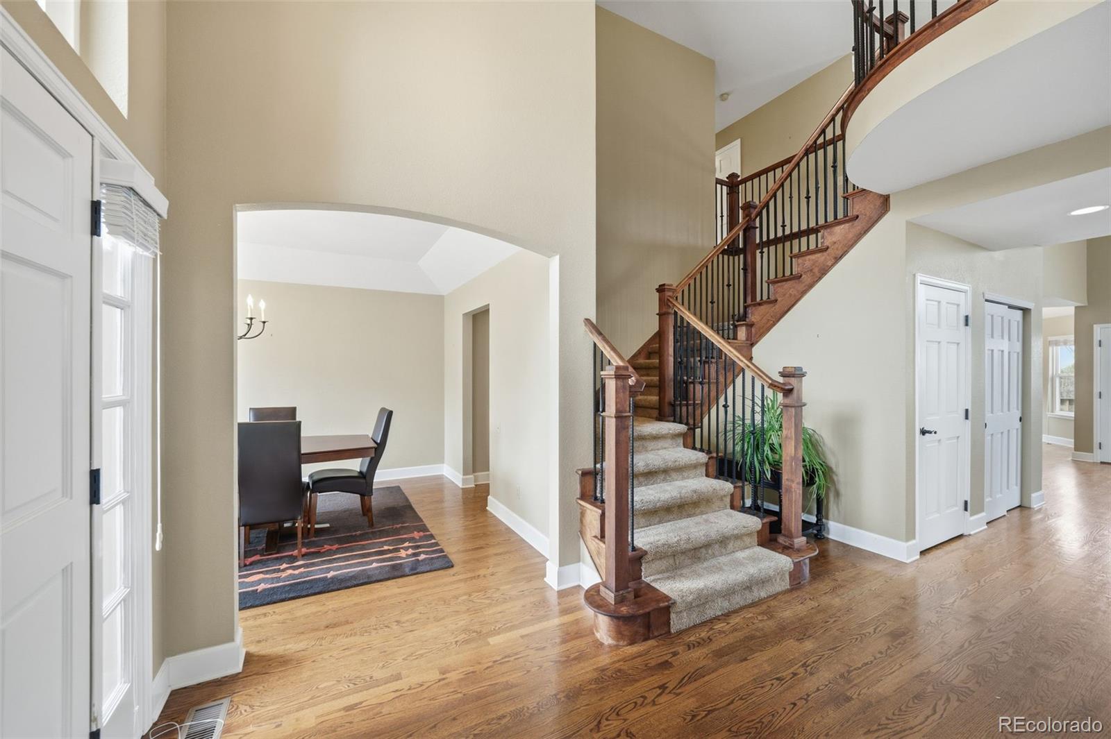 6879 Ingleton Drive Castle Pines, CO 80108 - Photo 4 of 50 a view of entryway and hall with wooden floor