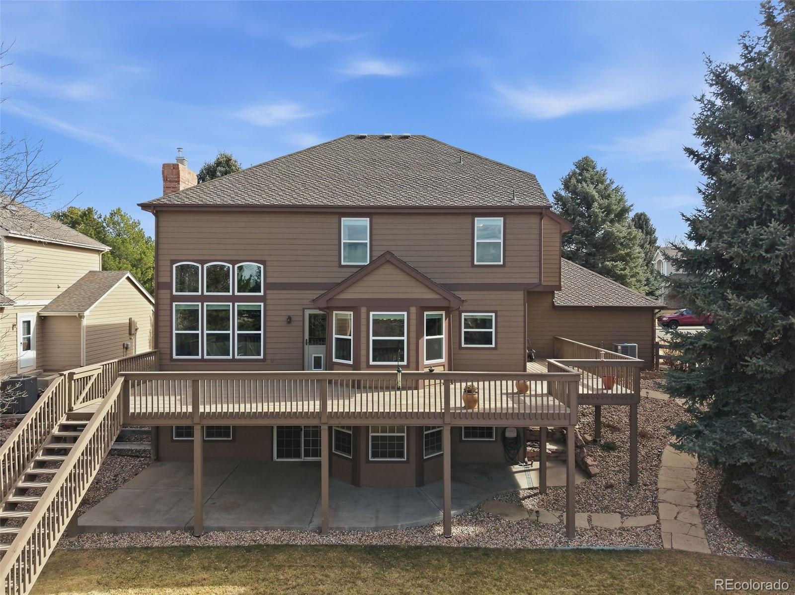6879 Ingleton Drive Castle Pines, CO 80108 - Photo 44 of 50 a front view of a house with a yard