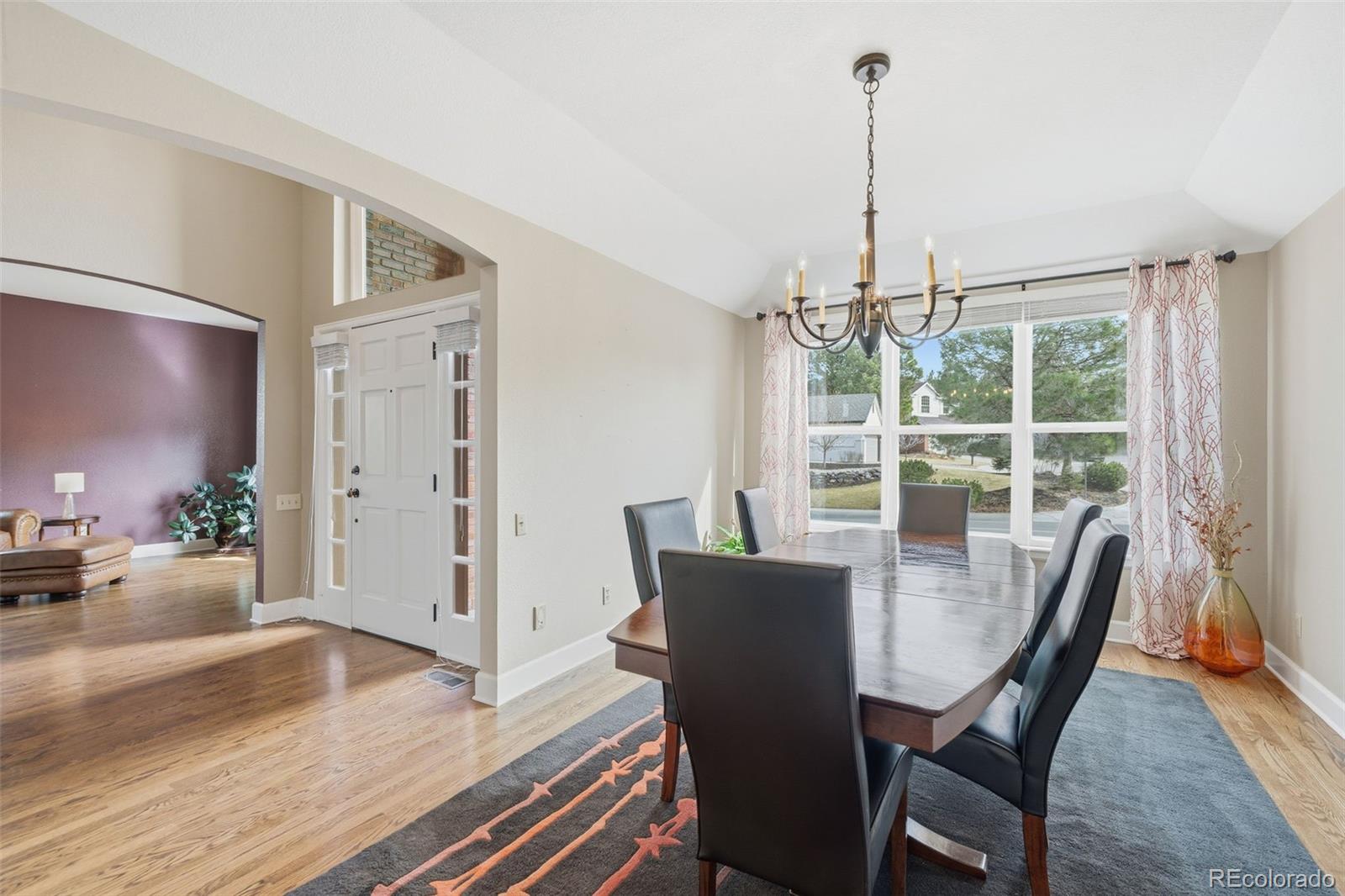 6879 Ingleton Drive Castle Pines, CO 80108 - Photo 8 of 50 a view of a dining room with furniture window and wooden floor