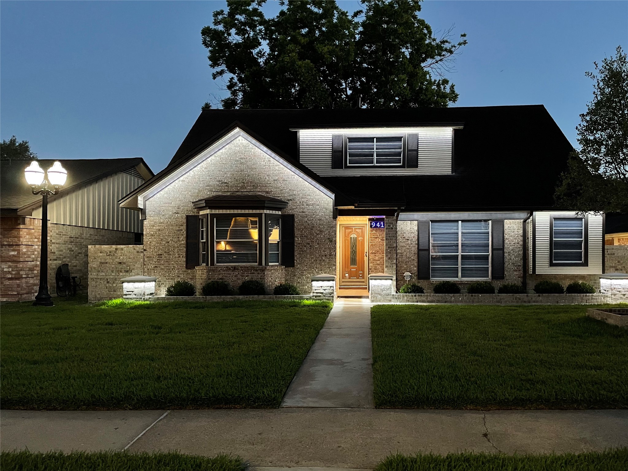 9411 Roos Road Houston, TX 77036 - Photo 5 of 41 a front view of a house with a yard