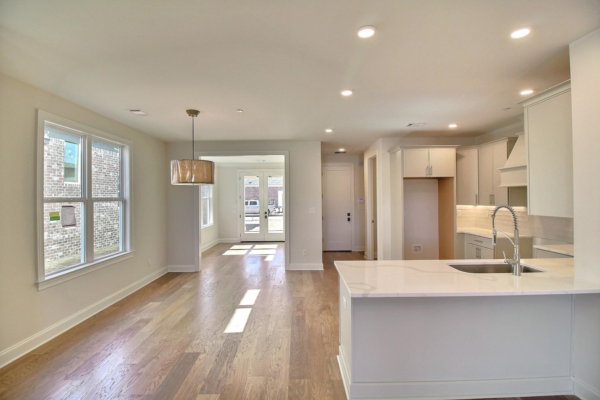 110 Rambling Rex Trail Collierville, TN 38017 - Photo 14 of 36 a large kitchen with kitchen island a sink stainless steel appliances and a large window