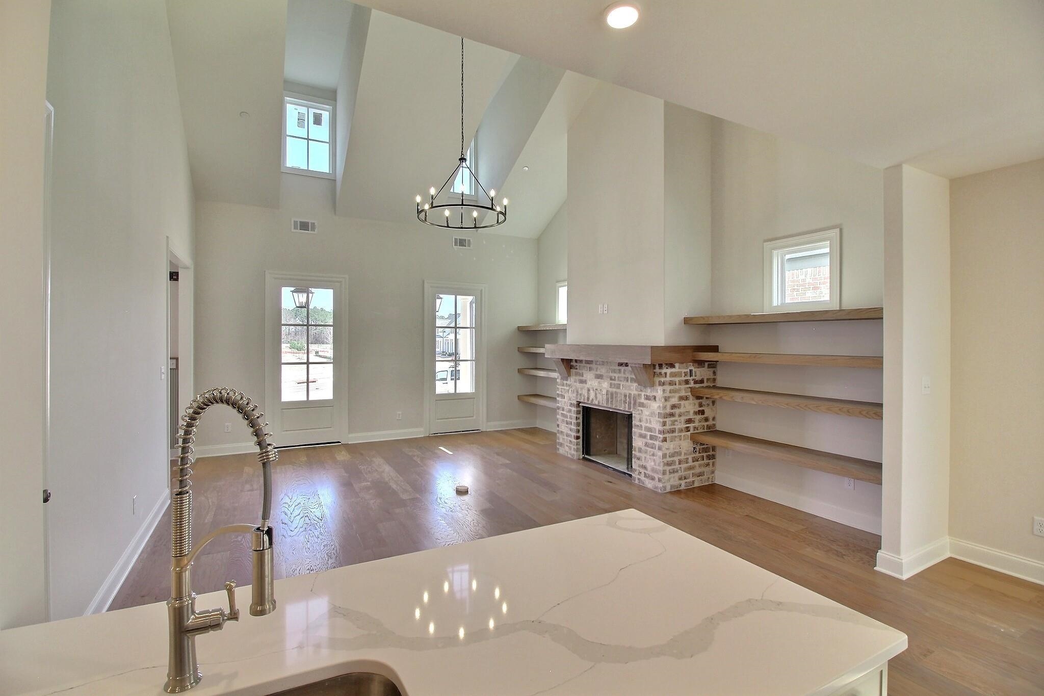 110 Rambling Rex Trail Collierville, TN 38017 - Photo 15 of 36 a view of a livingroom with a fireplace a chandelier and windows