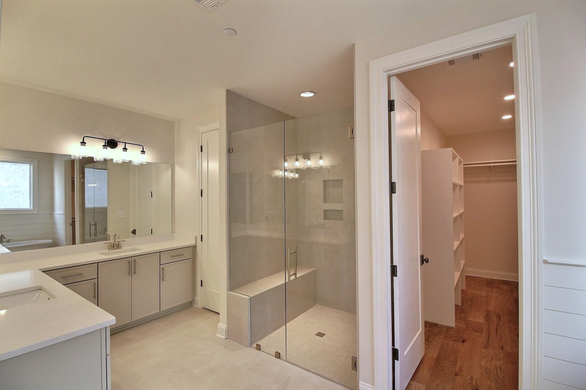 110 Rambling Rex Trail Collierville, TN 38017 - Photo 25 of 36 a bathroom with a mirror a double vanity sink and glass door