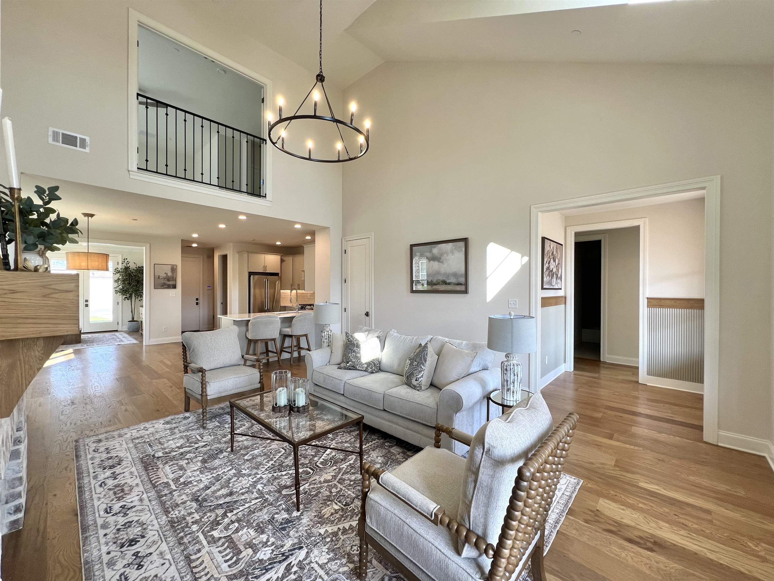 110 Rambling Rex Trail Collierville, TN 38017 - Photo 7 of 37 Living room with light wood-style floors, a chandelier, and high vaulted ceiling