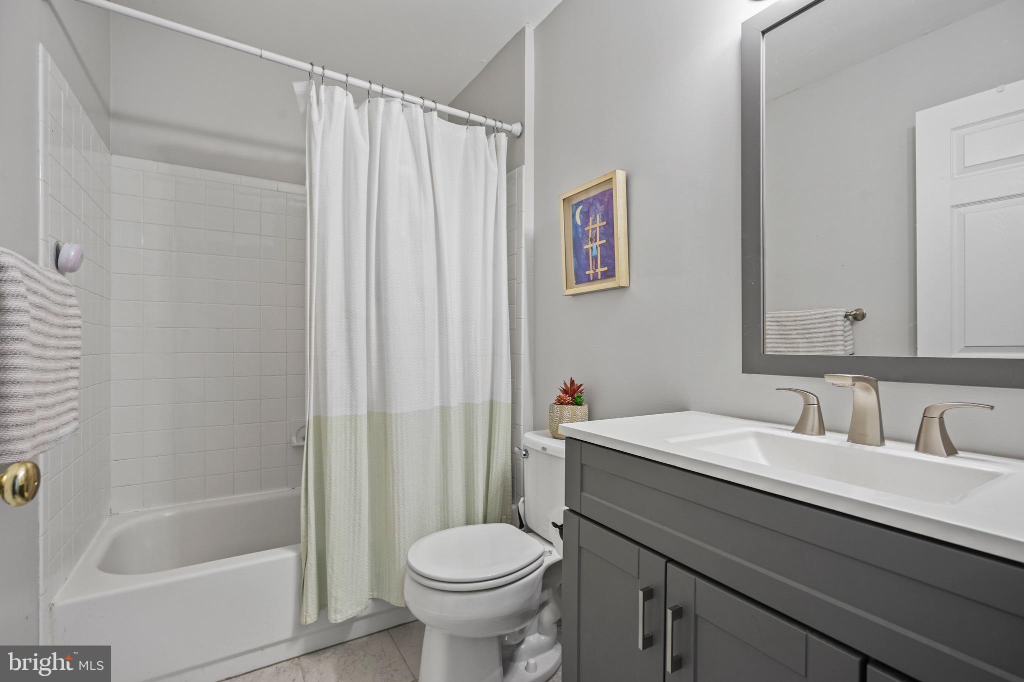 157 Setter Place Freehold, NJ 07728 - Photo 16 of 22 a bathroom with a sink a toilet and a bathtub