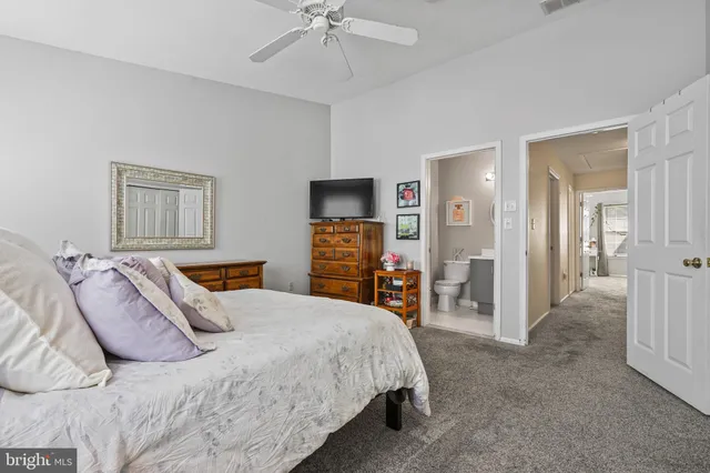 a bedroom with a bed and a flat tv screen