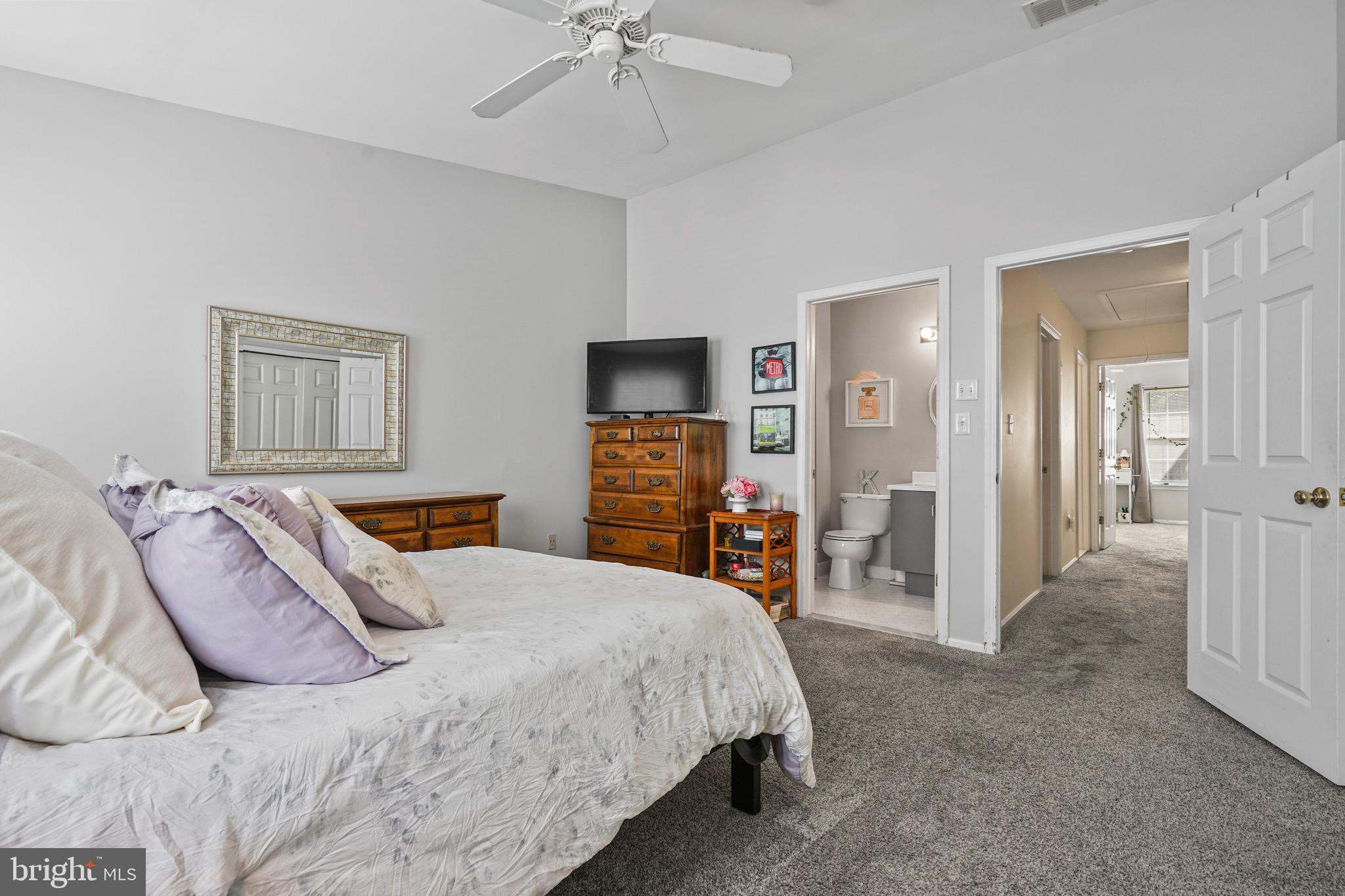 157 Setter Place Freehold, NJ 07728 - Photo 18 of 22 a bedroom with a bed and a flat tv screen