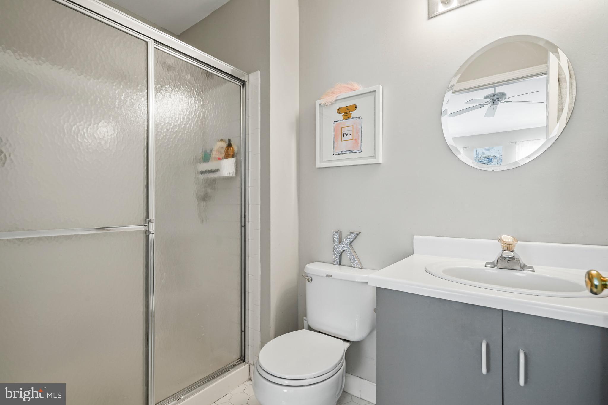 157 Setter Place Freehold, NJ 07728 - Photo 19 of 22 a bathroom with a toilet a sink a mirror and vanity