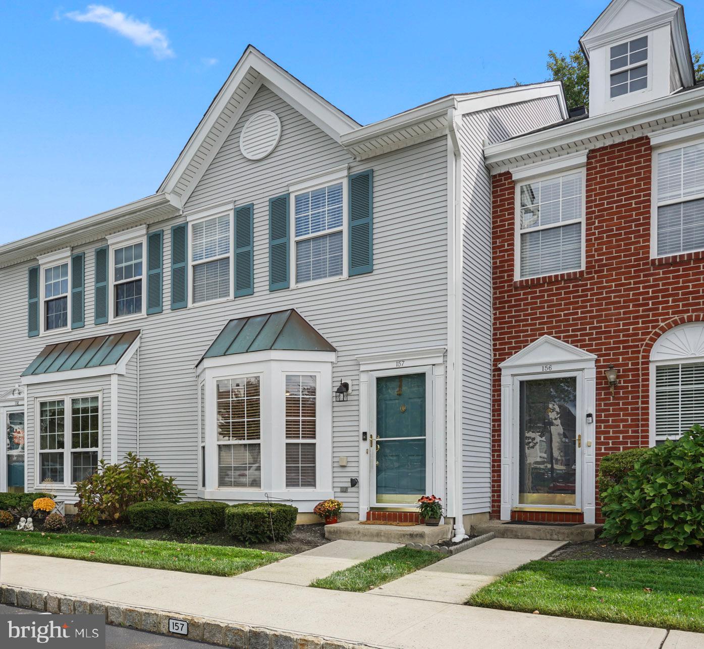 157 Setter Place Freehold, NJ 07728 - Photo 2 of 22 a front view of a house with garden and garage