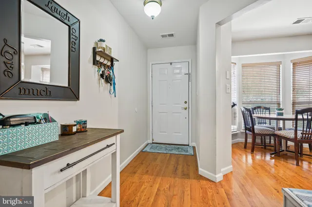 a kitchen view of a dining table chairs and entryway