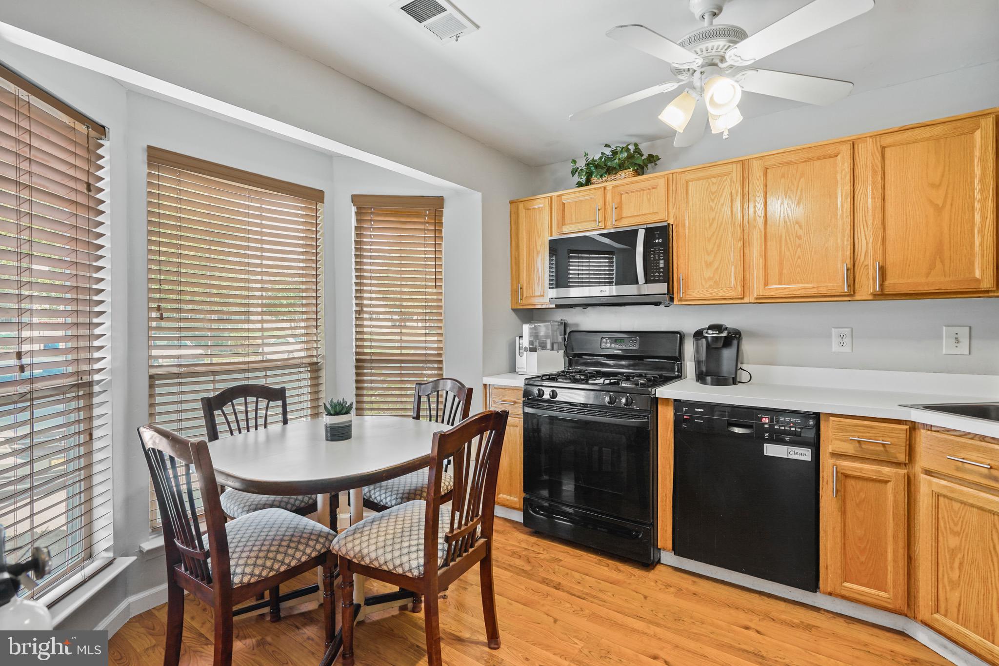 157 Setter Place Freehold, NJ 07728 - Photo 6 of 22 a kitchen with stainless steel appliances granite countertop a stove a sink dishwasher a dining table and chairs