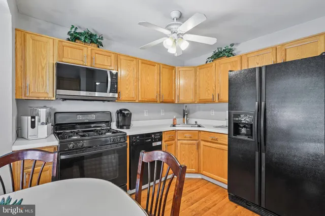 a kitchen with stainless steel appliances granite countertop a refrigerator a stove top oven a sink and dishwasher