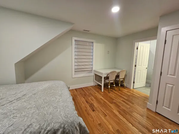 a bathroom with a sink a toilet and a window