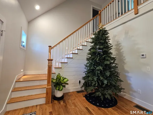 a living room with stainless steel appliances kitchen island granite countertop furniture a refrigerator a sink a stove and a microwave