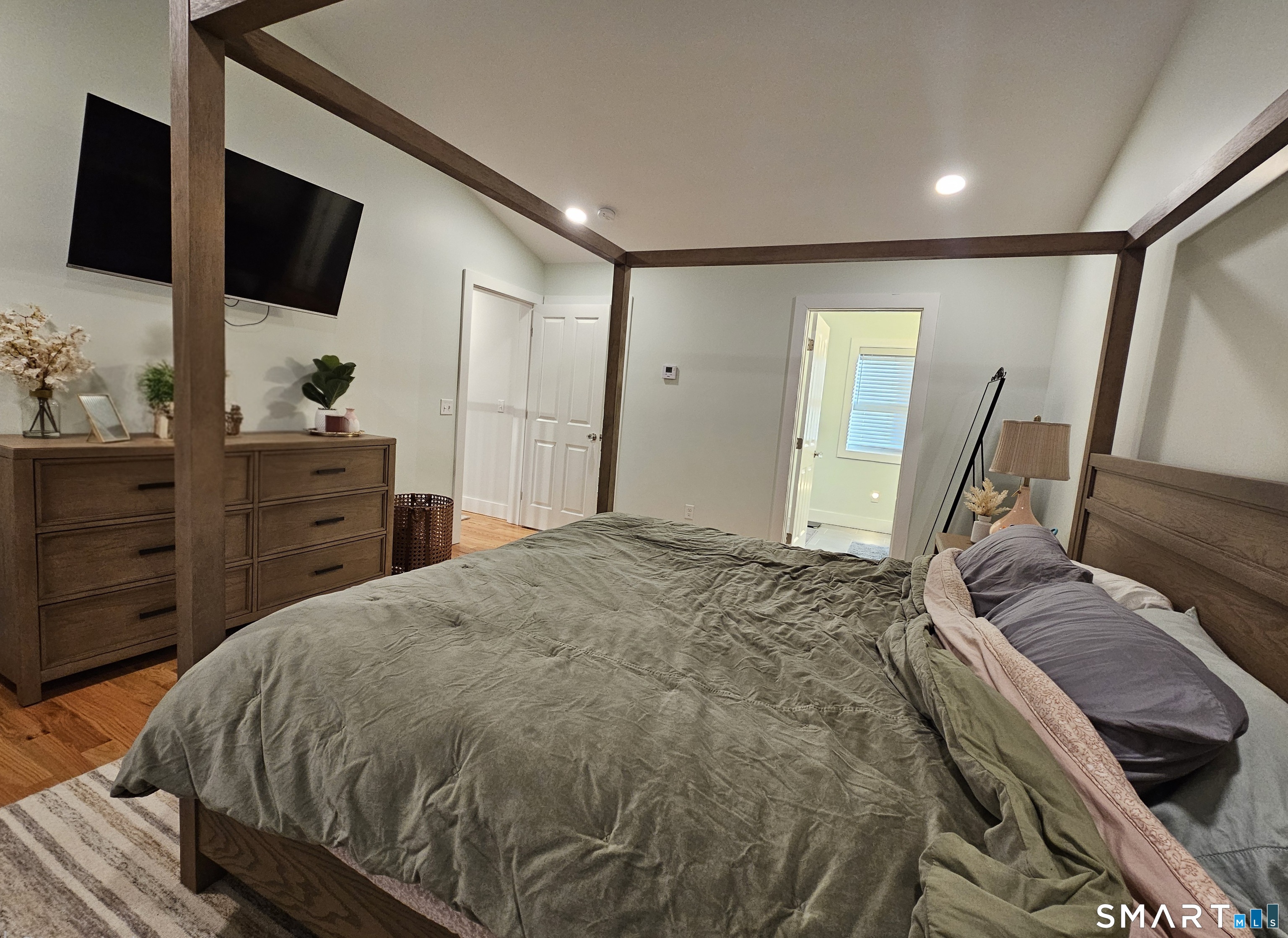 23 Ivy Hill Road, Unit 23 Waterford, CT 06385 - Photo 7 of 28 a spacious bedroom with a bed and a flat screen tv