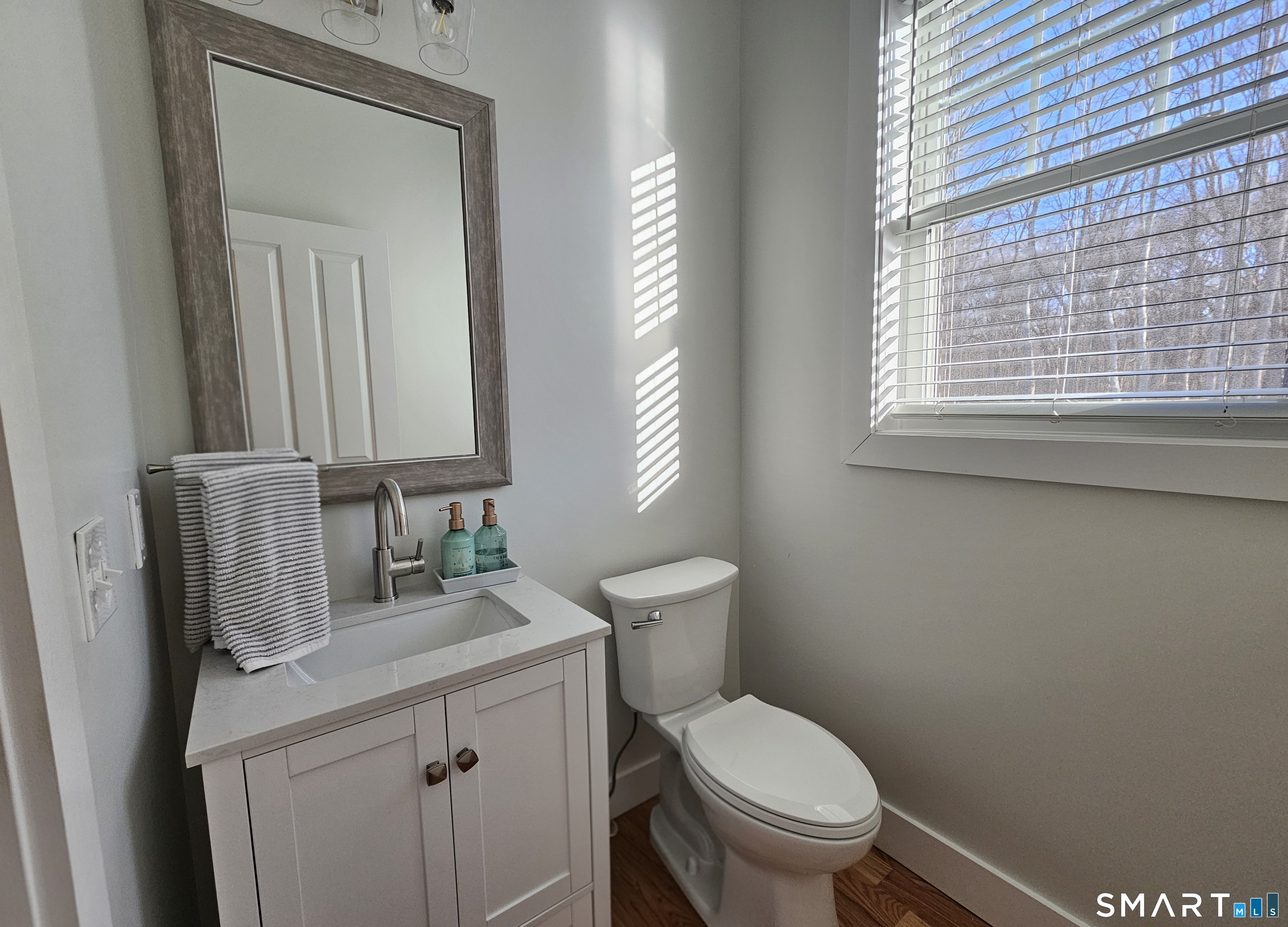 23 Ivy Hill Road, Unit 23 Waterford, CT 06385 - Photo 10 of 28 a bathroom with a toilet a sink a mirror and a window