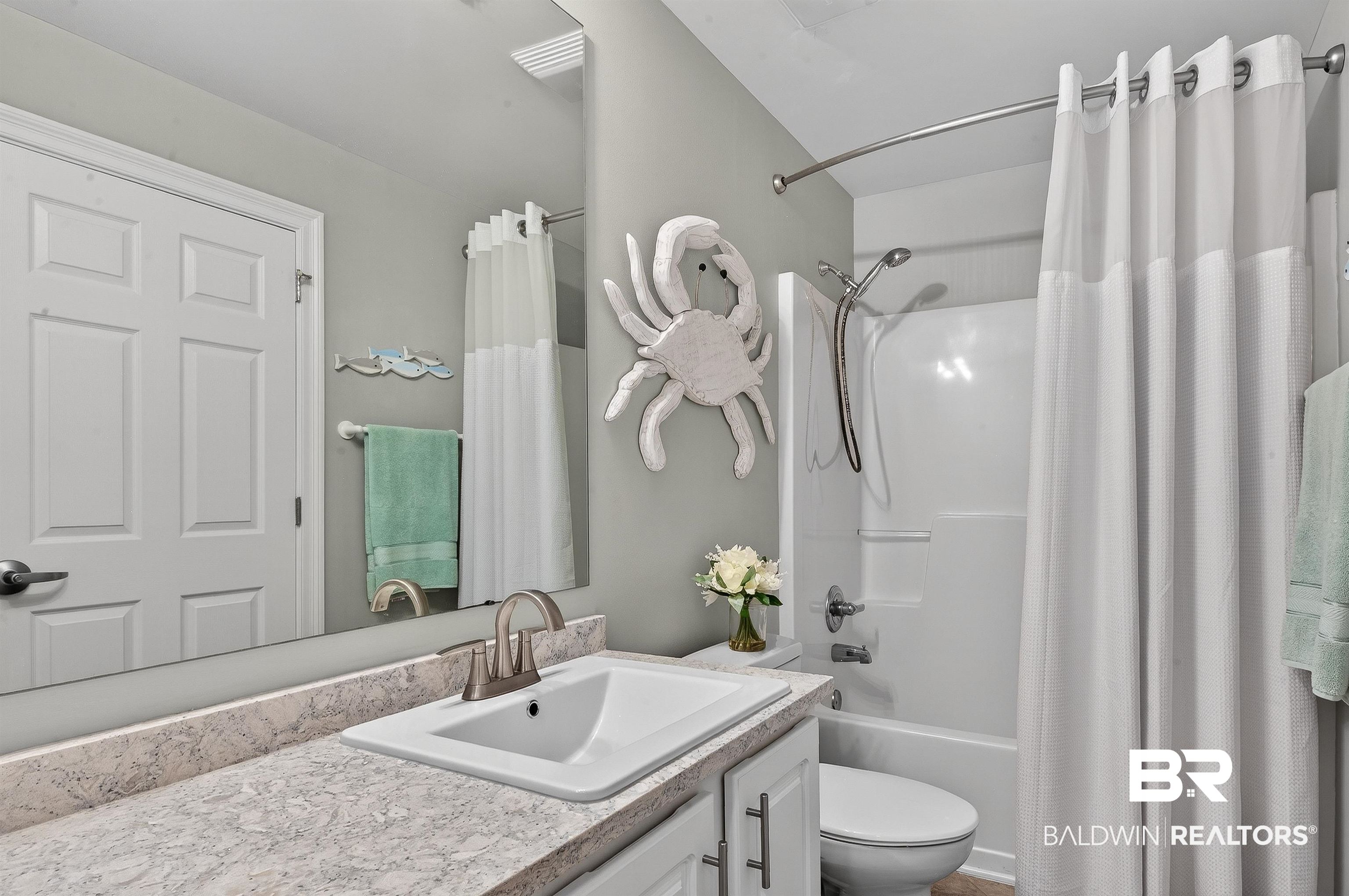 27282 Canal Road, Unit 408 Orange Beach, AL 36561 - Photo 18 of 37 Bathroom with vanity and shower / tub combo with curtain