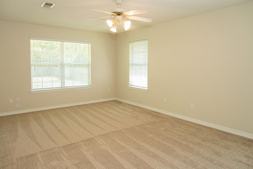 6805 Fernandina Road Navarre, FL 32566 - Photo 14 of 29 an empty room with windows and fan