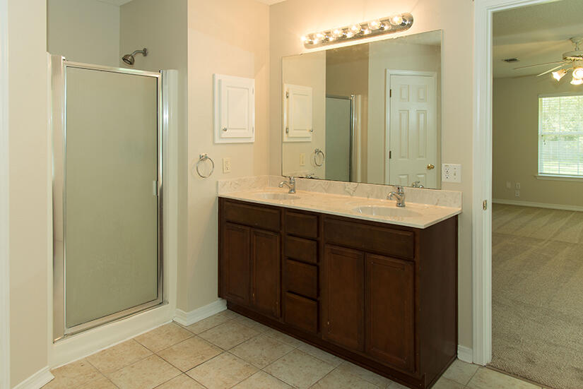 6805 Fernandina Road Navarre, FL 32566 - Photo 16 of 29 a bathroom with a double vanity sink mirror and double