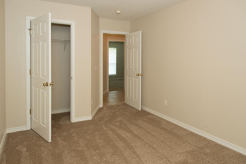 6805 Fernandina Road Navarre, FL 32566 - Photo 19 of 29 a view of an empty room with closet and wooden door