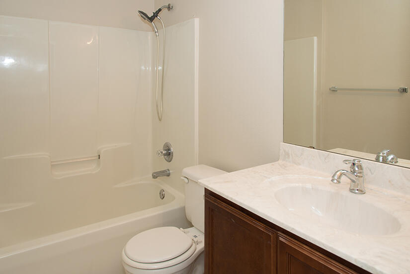 6805 Fernandina Road Navarre, FL 32566 - Photo 24 of 29 a bathroom with a sink a toilet and a bathtub